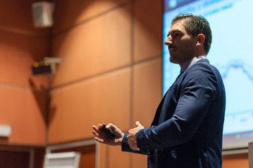 Speaker giving talk at Business Conference.
