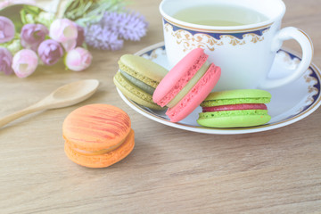 Cup of tea with colorful macaroons