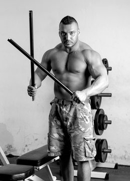 Strong man prepare for stick fighting