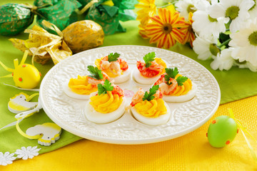 Fototapeta na wymiar Eggs stuffed with creamy mousse and crayfish.
