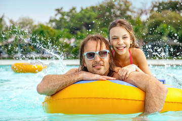 Father with daughter in water park