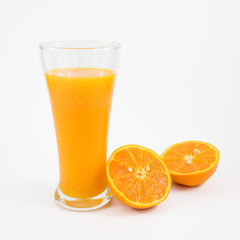The glass of tasty pure orange juice and fresh orange half for a good healthy.