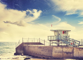 Retro toned picture of lifeguard tower at sunset, California, USA