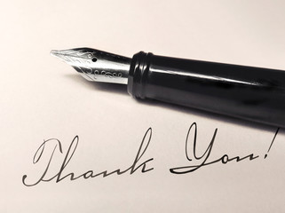 fountain pen and paper with thank you writing