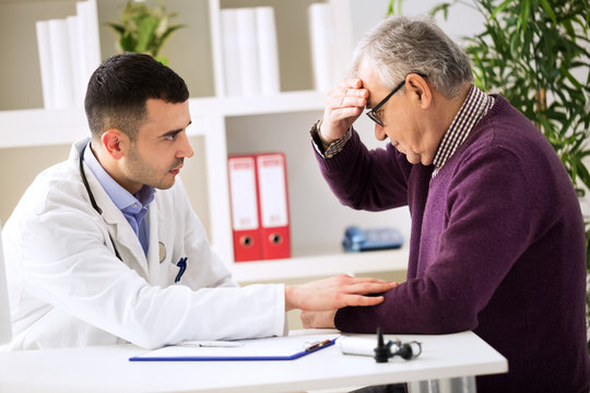Doctor listening to patient explaining his painful