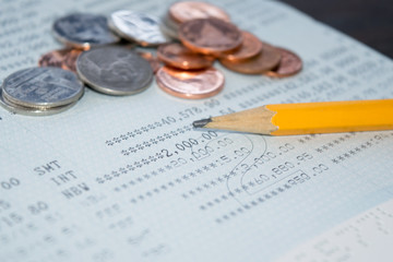 Obraz premium Saving Account Passbook bank account and pencil and coin abstract background