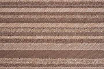 Striped brown and beige textile pattern as a background. Close u