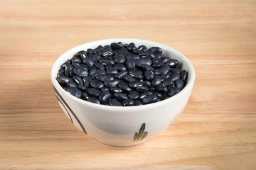 bowl of black bean on the wood background