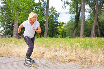 Adult woman in-line skating in a city park for healthy exercise and relaxation