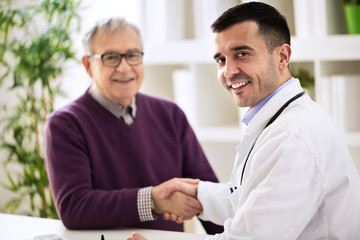Doctor shakes hands with a patient
