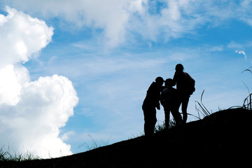 Silhouette travel family on mountain and Cloud blue sky