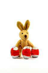 Easter Bunny standing between three chocolate eggs