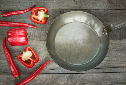 Red Hot Chili Peppers, paprika and pan  on vintage wooden board. Top view with copy space.