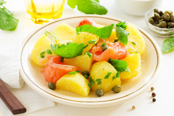 Boiled potatoes with green onions and salt salmon.