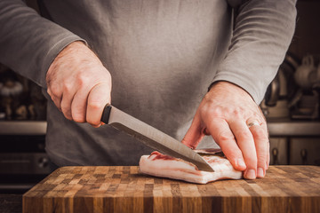 Man cutting lard