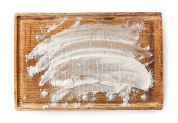white flour on wooden cutting board