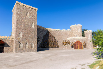 The castle with crenellated towers. The statues of knights in armor at the entrance