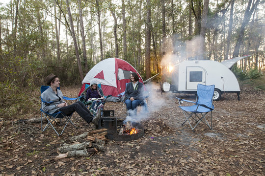 Mother And Kids Camping With Tent And Teardrop Trailer