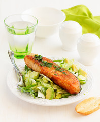 Fresh grilled salmon with a salad of avocado.