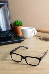 Eye glasses with laptop and cup of coffee