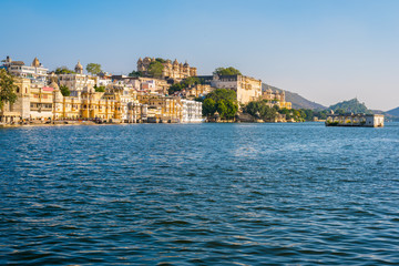 Fototapeta na wymiar Lake Pichola with historical buildings of Udaipur old city in the background
