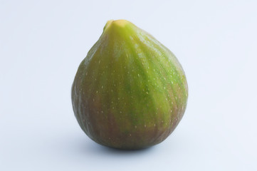 Single ripe fig resting isolated on white background