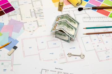 architectural drawings for houses with dollar, paints, brushes and accessories