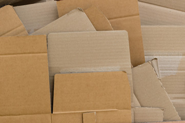 Pieces of recycled cardboard flattened and arranged pile