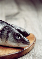 Raw seabass fish on the wooden board