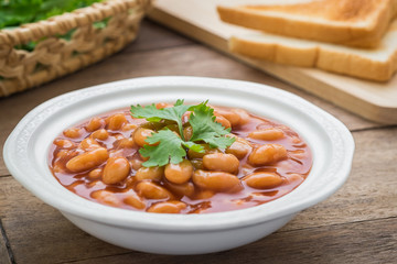 Baked beans in tomato sauce on plate and toast