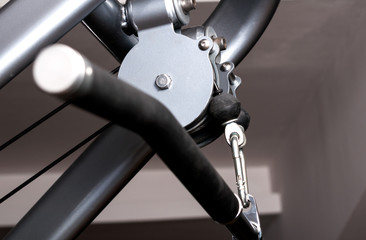 Close up pulley of gym equipment with handle