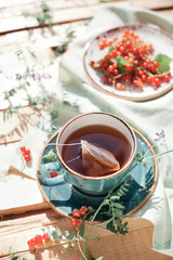 Cup of organic black tea with tea bag in it