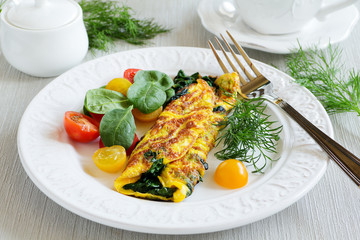 Omelet with spinach and lettuce tomato.