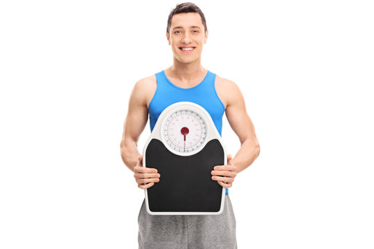Young athlete holding a weight scale