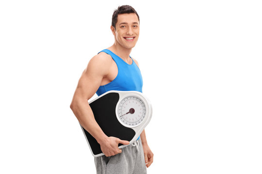 Man in sportswear holding a weight scale