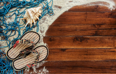 Marine items on wooden background. Sea objects - seashells, corals on wooden planks. Beach still life. View from above