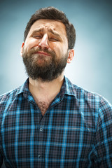 Obraz premium The crying man with tears on face closeup