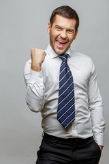 Handsome stylish businessman on grey background