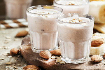 Smoothie with banana, yogurt, oatmeal and nuts, selective focus