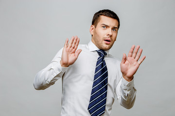 Handsome stylish businessman on grey background