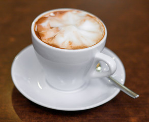 Cappuccino in a white cup on the table