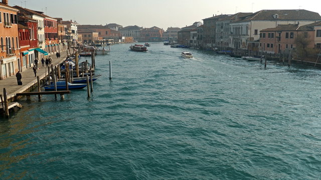 MURANO, ITALY - JANUARY 25, 2016: Venice, Italy, Murano water boats canal and traditional buildings.117 islands separated by canals and bridges. Murano is glass making island. World Heritage Site. 4K.