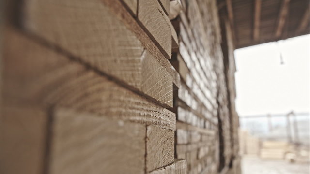 stack of pile wood bar in lumber yard factory use for construction wood industry. RAW video record.