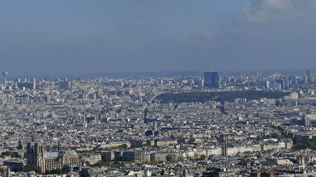 Panoramic footage in 4k with Paris from Montparnasse tower. Aerial view including cathedral Notre-Dame and  different historical and commercial buildings.