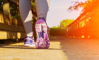 Woman running at sunset in a field