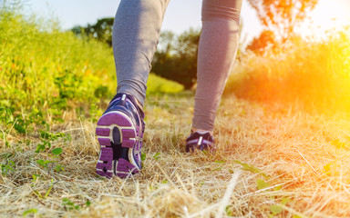 Woman running at sunset in a field