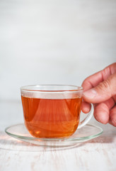 Man hand holding cup of tea