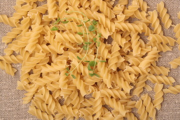 Closeup of Uncooked Italian Spiral Pasta - Rotini with oregano o