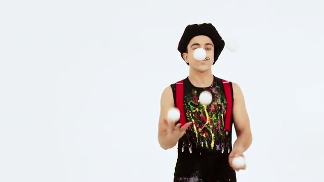 Juggler showing tricks with five balls. Slow motion