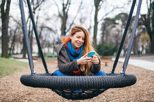 Young woman using smartphone in the park